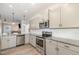 Bright kitchen features stainless appliances, gray cabinets, and granite countertops at 72 Ina Rose Ln, Four Oaks, NC 27524