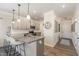 Contemporary kitchen with granite countertops, gray cabinets, and bar stool seating at 72 Ina Rose Ln, Four Oaks, NC 27524