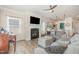 Inviting living room with fireplace, piano and access to the modern kitchen at 72 Ina Rose Ln, Four Oaks, NC 27524