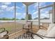 Relaxing screened-in porch with comfortable seating overlooking the large fenced-in backyard at 72 Ina Rose Ln, Four Oaks, NC 27524