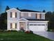 Charming two-story home features a two-car garage, stone accents, and beautifully landscaped front yard at 736 Deschutes Dr, Garner, NC 27529
