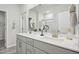 Bright bathroom with double sink vanity, large mirror, and glass-enclosed shower at 740 Deschutes Dr, Garner, NC 27529