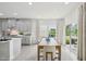 Bright and airy dining room adjacent to the kitchen, featuring hardwood floors and large windows with backyard views at 740 Deschutes Dr, Garner, NC 27529