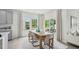 Bright dining room with wood table, modern chairs, large windows and sliding glass door leading outside at 740 Deschutes Dr, Garner, NC 27529