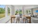 Elegant dining room featuring a wooden table, comfortable seating, large windows, and stylish curtains at 740 Deschutes Dr, Garner, NC 27529
