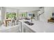 Open-concept kitchen with quartz countertop island flowing into dining and living areas with abundant natural light at 740 Deschutes Dr, Garner, NC 27529