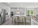 Modern kitchen featuring stainless steel appliances, light gray cabinetry, a large island, and breakfast bar seating at 740 Deschutes Dr, Garner, NC 27529