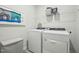 Efficient laundry room equipped with a washer and dryer, along with storage solutions at 740 Deschutes Dr, Garner, NC 27529