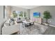 Open living room featuring neutral walls, gray floors, large windows and a comfortable white sofa at 740 Deschutes Dr, Garner, NC 27529