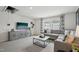 Cozy living room with gray sectional, stylish furniture, and a television for entertainment at 740 Deschutes Dr, Garner, NC 27529