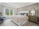 Serene main bedroom features a tray ceiling, soft lighting, and large windows with outdoor views at 740 Deschutes Dr, Garner, NC 27529