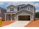 Charming two-story home featuring a two-car garage and classic gray siding at 744 Deschutes Dr, Garner, NC 27529