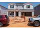 Two-story home under construction with a two-car garage and light gray siding with dark shutters at 748 Deschutes Dr, Garner, NC 27529