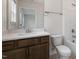 Bathroom featuring a wood vanity with quartz countertop, a shower, and a toilet at 79 Bronco Pace Dr, Clayton, NC 27520