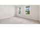 Bedroom with neutral carpeting and two large windows, offering natural light at 79 Bronco Pace Dr, Clayton, NC 27520