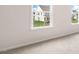 A bright bedroom features neutral carpeting and paint with two windows showing a suburban view at 79 Bronco Pace Dr, Clayton, NC 27520