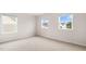 A carpeted bedroom has three windows providing natural light and neutral walls with white trim at 79 Bronco Pace Dr, Clayton, NC 27520