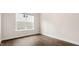 Neutral bedroom featuring hardwood floors and a window providing natural light at 79 Bronco Pace Dr, Clayton, NC 27520