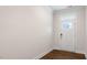 Bright entry foyer with a white door with glass panel and a transom window above, hardwood flooring at 79 Bronco Pace Dr, Clayton, NC 27520