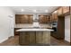 Spacious kitchen featuring a central island, stylish cabinetry, and modern stainless steel appliances at 79 Bronco Pace Dr, Clayton, NC 27520