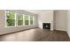 Inviting living room with hardwood floors, a fireplace, and expansive windows with bright light at 79 Bronco Pace Dr, Clayton, NC 27520