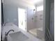 Bright bathroom with double vanity, walk-in shower, and modern fixtures at 802 Shade Tree Rd, Benson, NC 27504