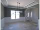 Bright dining room with wainscoting, elegant chandelier, and a view of the front entrance at 802 Shade Tree Rd, Benson, NC 27504