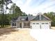 Charming home featuring a two-car garage, a welcoming entrance, and a well-manicured front yard at 802 Shade Tree Rd, Benson, NC 27504