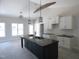Kitchen features modern island with sink, granite countertops, white cabinets, and pendant lighting at 802 Shade Tree Rd, Benson, NC 27504
