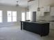 Unfinished kitchen with large island, white cabinetry, and modern pendant lighting fixtures at 802 Shade Tree Rd, Benson, NC 27504