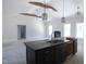 Spacious open floor plan shows kitchen island, sink, dark cabinets and modern lighting fixtures at 802 Shade Tree Rd, Benson, NC 27504