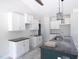 Bright kitchen with white cabinets, a dark island, granite countertops, and stylish lighting at 802 Shade Tree Rd, Benson, NC 27504