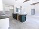 Unfinished kitchen boasts a large island with dark cabinetry and modern lighting fixtures at 802 Shade Tree Rd, Benson, NC 27504