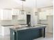 Well-lit kitchen featuring an island, granite countertops, and white cabinetry at 802 Shade Tree Rd, Benson, NC 27504