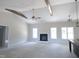 Unfinished living room boasts high ceilings, fireplace, ceiling fan and lots of natural light at 802 Shade Tree Rd, Benson, NC 27504