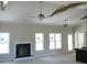 Unfinished living room featuring a fireplace, ceiling fan and abundant natural light at 802 Shade Tree Rd, Benson, NC 27504