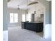 Bright open layout with high ceilings, a dark kitchen island, and large windows for natural light at 802 Shade Tree Rd, Benson, NC 27504