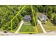 Aerial view of the home showcasing lush landscaping, long driveway, and property lines at 8304 Southmoor Hill Trl, Wake Forest, NC 27587