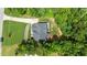 Aerial view showcasing the roofline and surrounding greenery with the home set back on the lot at 8304 Southmoor Hill Trl, Wake Forest, NC 27587