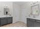 Bright bathroom features dual vanities with gray cabinets, tile floors and modern lighting at 8304 Southmoor Hill Trl, Wake Forest, NC 27587