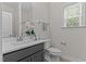 Elegant half bathroom with gray vanity, white countertops, and stylish fixtures at 8304 Southmoor Hill Trl, Wake Forest, NC 27587