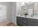 Bright bathroom featuring double vanity, modern fixtures and finishes, with a view to the shower at 8304 Southmoor Hill Trl, Wake Forest, NC 27587