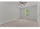 Cozy bedroom featuring neutral carpeting and a ceiling fan, perfect for relaxation at 8304 Southmoor Hill Trl, Wake Forest, NC 27587