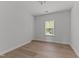 Spacious bedroom featuring hardwood floors and bright natural light from the window at 8304 Southmoor Hill Trl, Wake Forest, NC 27587