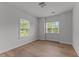Empty bedroom featuring two windows and hardwood floors providing ample natural light at 8304 Southmoor Hill Trl, Wake Forest, NC 27587