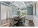 Dining room with coffered ceiling and chandelier is bright and open to the entryway at 8304 Southmoor Hill Trl, Wake Forest, NC 27587