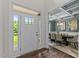 Inviting entryway featuring a white door and a glimpse into the dining room with beautiful coffered ceilings at 8304 Southmoor Hill Trl, Wake Forest, NC 27587
