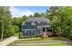 Charming two-story home with a manicured lawn and mature trees offering shade and curb appeal at 8304 Southmoor Hill Trl, Wake Forest, NC 27587