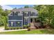 Inviting two-story home with landscaped front yard, brick-accented porch, and elegant curb appeal at 8304 Southmoor Hill Trl, Wake Forest, NC 27587