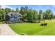 Expansive front lawn complements this two-story home, showcasing meticulous landscaping and natural beauty at 8304 Southmoor Hill Trl, Wake Forest, NC 27587